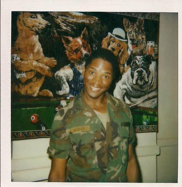 Young man in camouflage uniform, smiling