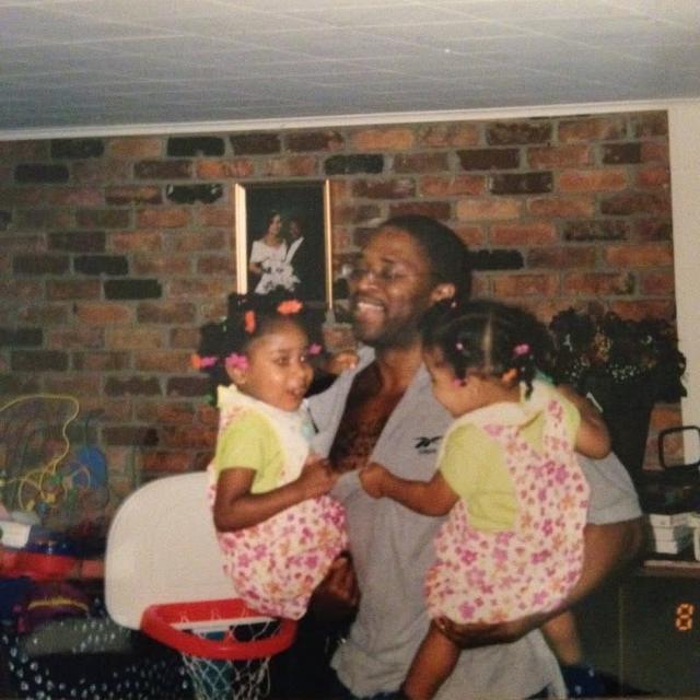 Father holding his two young daughters