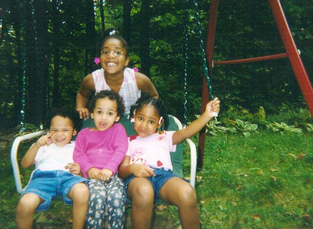 Young sisters on a swing