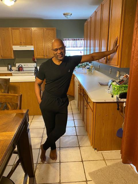 Standing in a kitchen, smiling