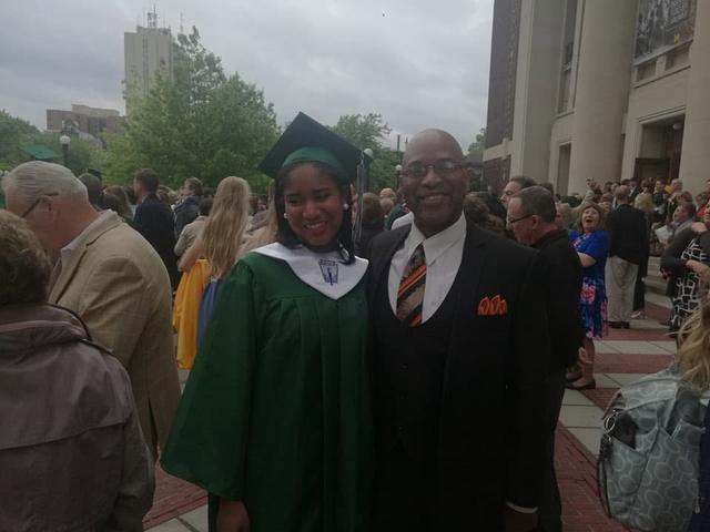 Commencement with a graduate in green
